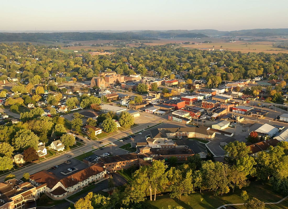 Hilliard, OH - Aerial View of Commercial Buildings and Homes Surrounded by Green Trees at Sunset in Hilliard Ohio